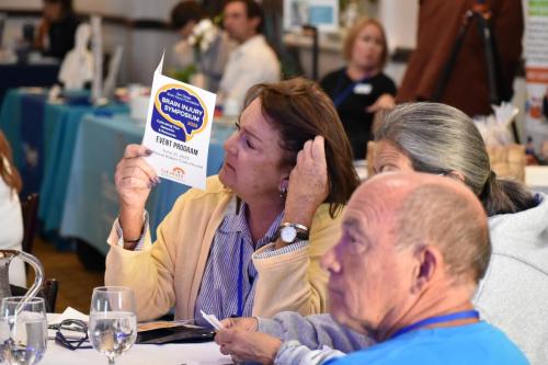 Guest reading the Symposium Program